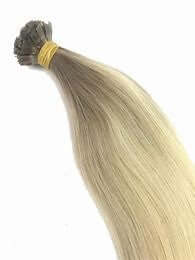 20" keratin weft flat tip hair extension in natural blend color, 100% human hair for seamless and long-lasting hold.