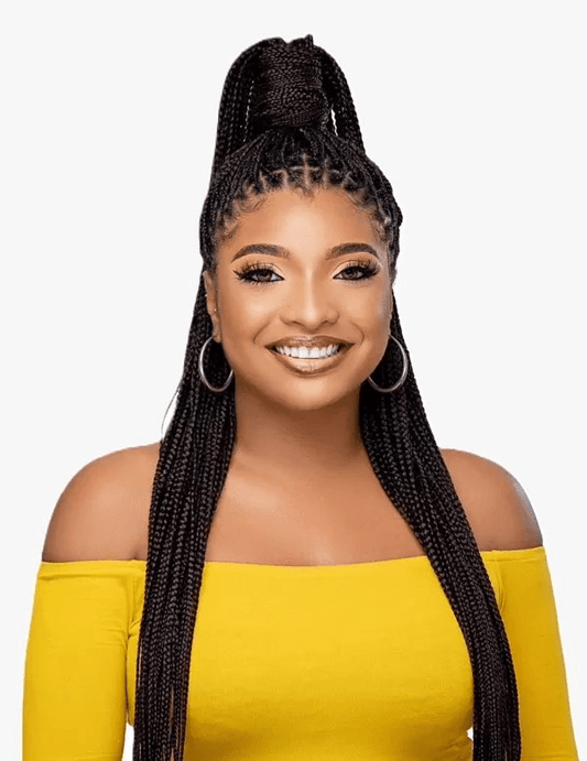 Woman with sleek box braids styled in a high ponytail, wearing a yellow off-shoulder top and smiling.